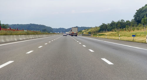 Surface level view of highway against sky