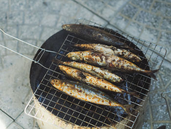 High angle view of meat on barbecue grill