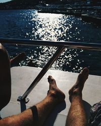 Low section of people sitting on boat sailing in river