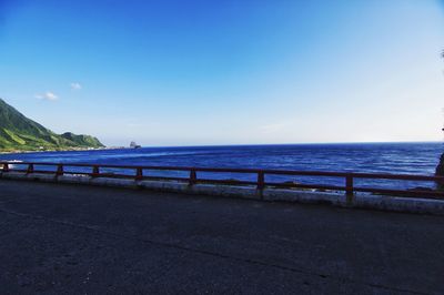 Scenic view of sea against clear blue sky