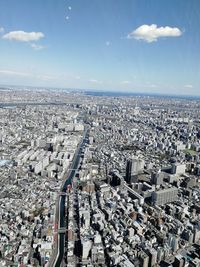 High angle view of city against cloudy sky