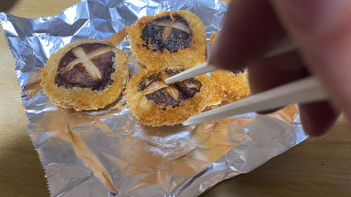 High angle view of hand holding cake