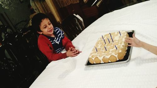 Portrait of smiling boy having food at home