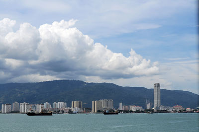 Sea with buildings in background