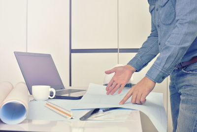 Low angle view of man using laptop on table