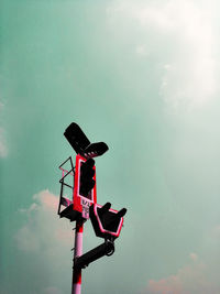 Low angle view of red light against sky