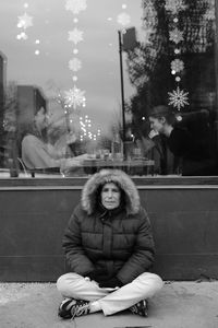 Portrait of young woman sitting outdoors