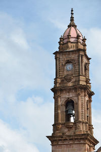 Low angle view of clock tower against sky