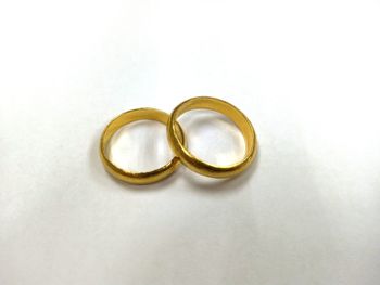 Close-up of wedding rings on white background