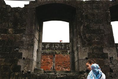 People standing in front of historic building