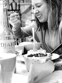 Smiling woman having food in restaurant