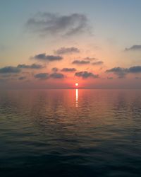 Scenic view of sea against romantic sky at sunset