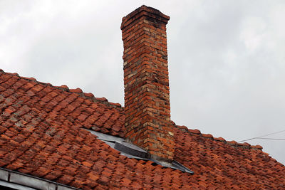 Low angle view of roof and building against sky