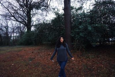 Young woman standing in forest