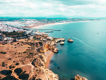 Ocean landscape with rocks and cliffs at lagos bay coast in algarve, portugal