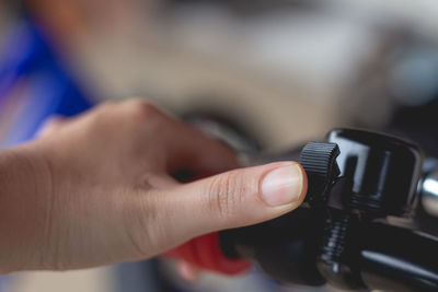 Close-up of thumb on bicycle bell