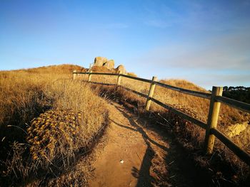 Fence on field against sky