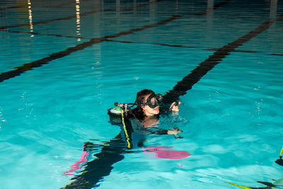 High angle view of young woman swimming in pool