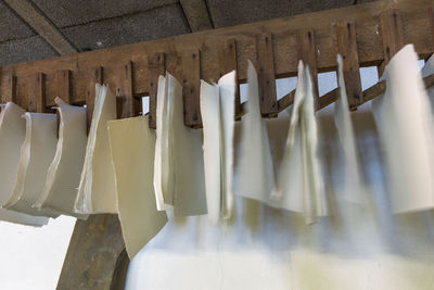 Low angle view of clothes drying against wall in building