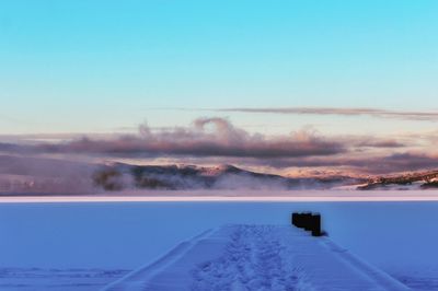 Scenic view of frozen lake against clear sky during winter