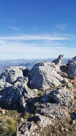 Rocks on mountain against blue sky