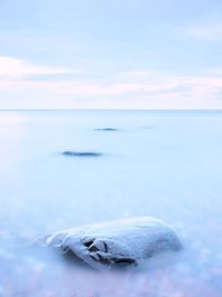 Alone stone in smooth sea. seascape with low lightt. sea and rock at the sunset. nature composition.