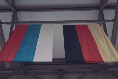 Low angle view of flag against blue sky