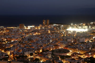 Aerial view of city lit up at night