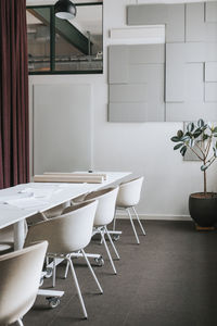 Chairs arranged near table with documents at office