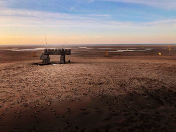 Scenic view of beach against sky during sunset