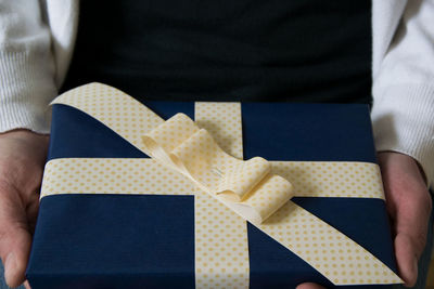 Cropped hands of man holding wrapped gift box