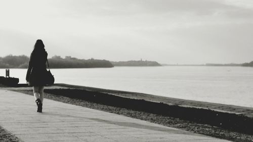 Rear view of woman looking at sea