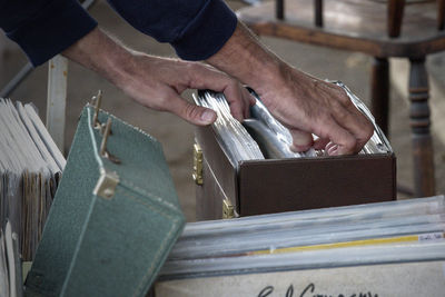 Midsection of man reading book on table