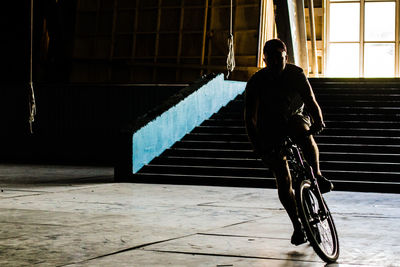 Rear view of a woman riding bicycle