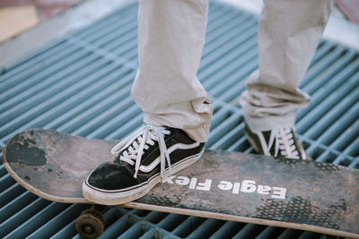 Low section of man standing on metal