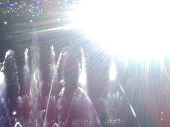 Low angle view of bright sun in sky