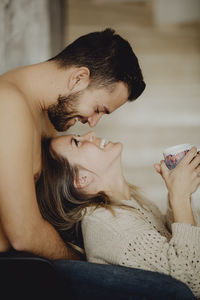 Midsection of couple holding hands