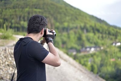 Man photographing against camera