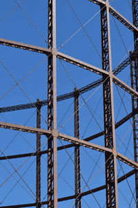 Low angle view of telephone pole against blue sky