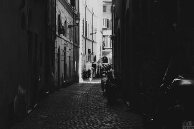 Narrow street amidst buildings in city