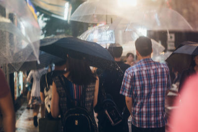 Rear view of people standing in city