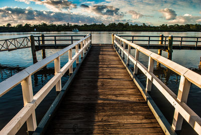 Pier over lake against sky