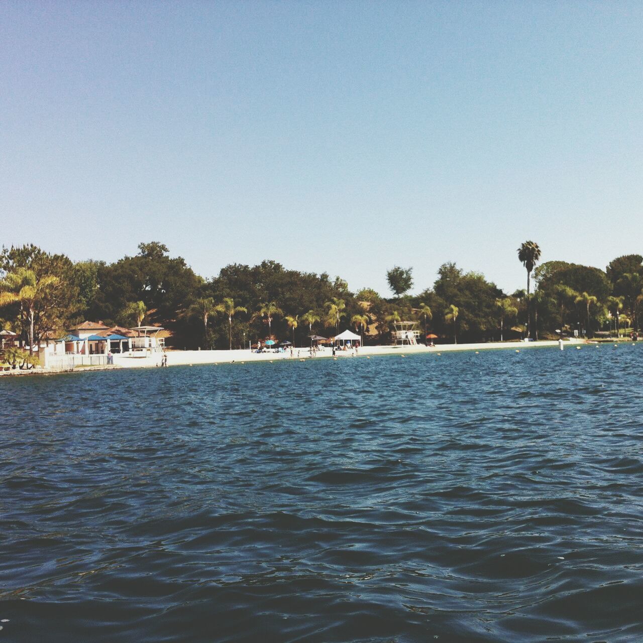 water, tree, clear sky, waterfront, copy space, tranquil scene, tranquility, scenics, rippled, blue, beauty in nature, nature, sea, nautical vessel, lake, building exterior, built structure, idyllic, river, sky