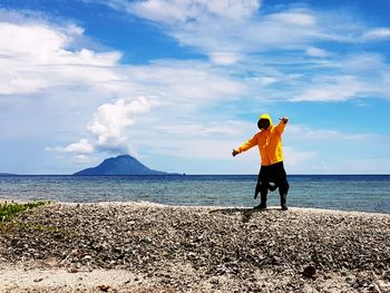 Man standing on beach against sky