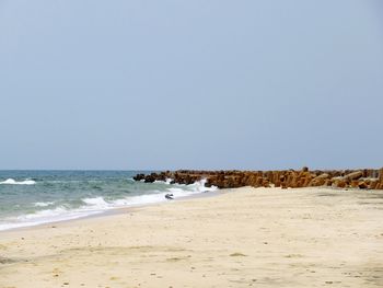 Scenic view of beach against clear sky