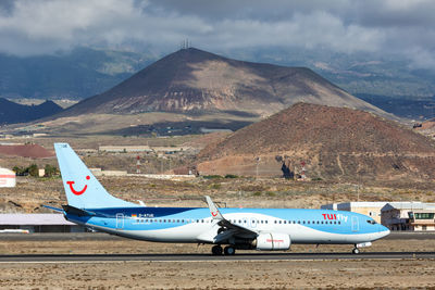 Airplane on beach against sky