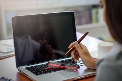 Woman using laptop on table