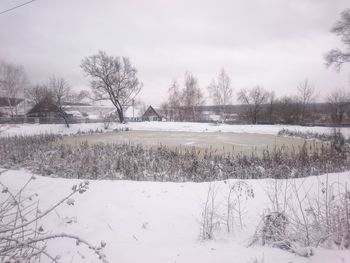 Scenic view of landscape against sky during winter