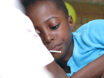 Close-up of boy lying down on bed at home