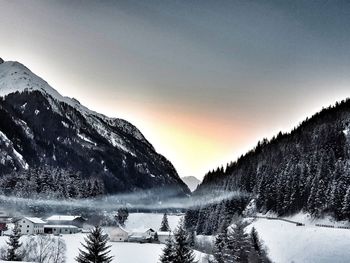 Scenic view of snow covered mountains against sky